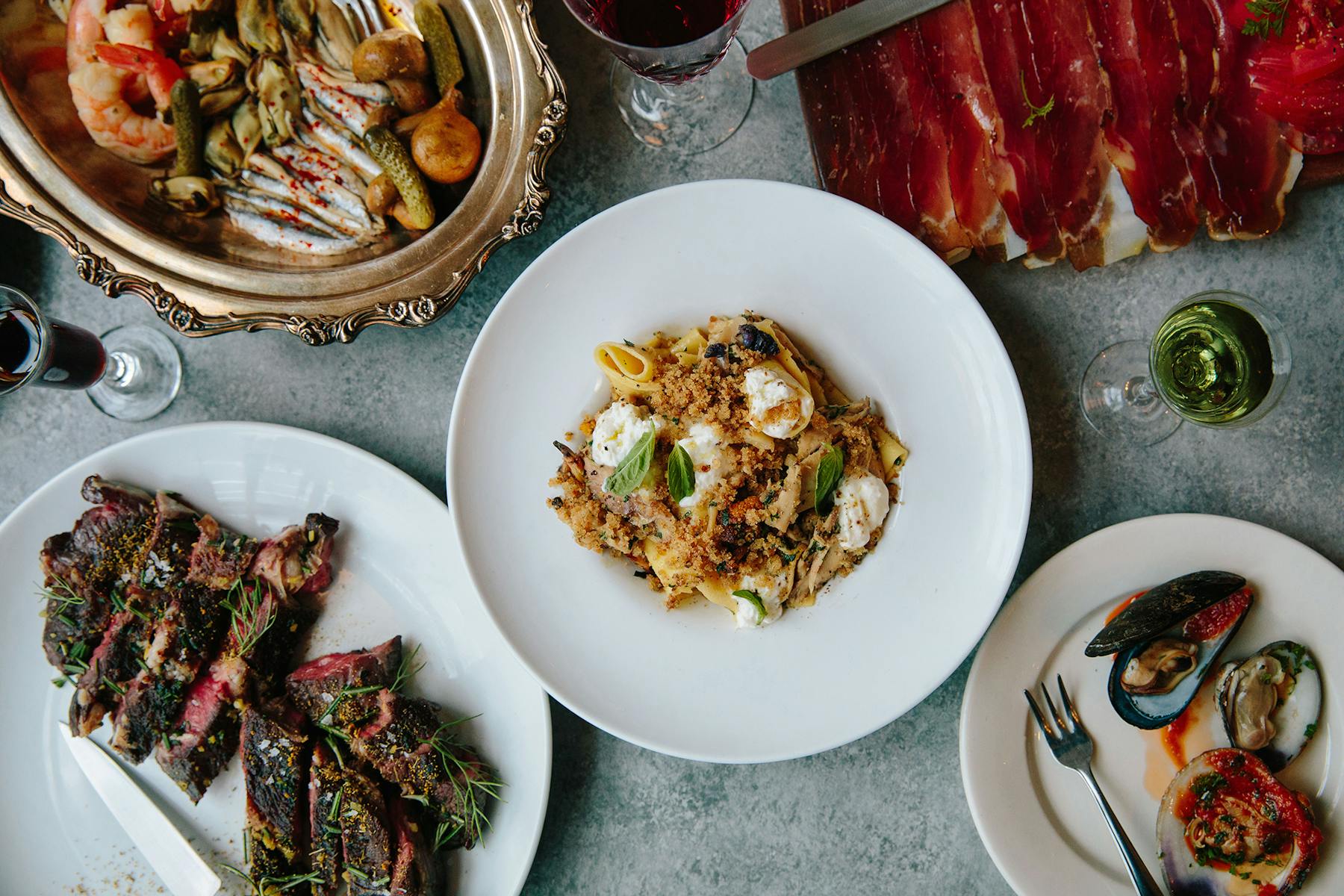 several plates and bowls of food